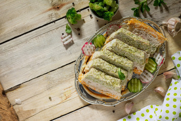 Meat cake made with minced meat, broccoli and carrots on a kitchen wooden table with fresh vegetables. The concept of a healthy diet.