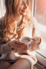 Young female holding cup of coffee