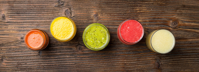 Fresh juices on an old wooden table