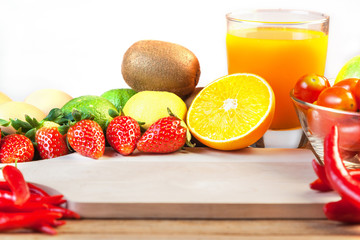 Healthy concept with mixed fruits and vegetables on wooden background