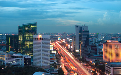 Landscape of Bangkok city at twilight time with road traffic.