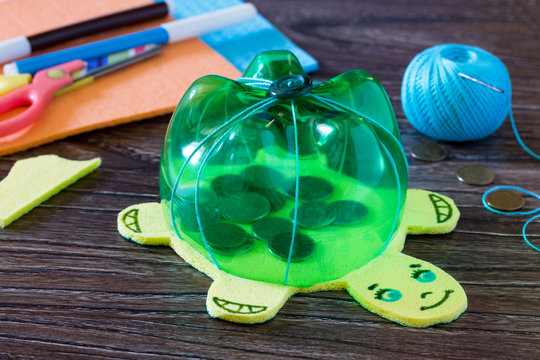 Children's hand-made article from a plastic bottle piggy bank for money. Handmade. Project of children's creativity, handicrafts, crafts for children.