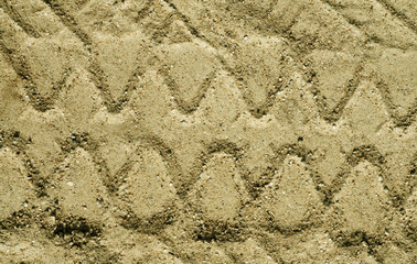 Truck tyre imprint on sand surface.