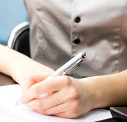 Young business woman writing at office