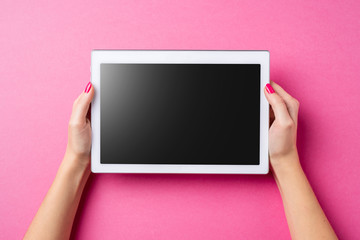 Woman holding white digital tablet. Close up