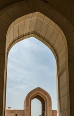 Fototapeta na wymiar Looking Through Arch at Sultan Qaboos Grand Mosque