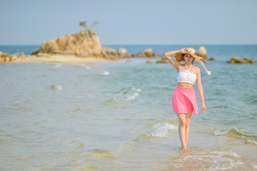 Fototapeta premium Woman wearing bikini standing in the sea.