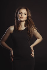 Naklejka premium Young brunette woman with magnificent hair in the wind