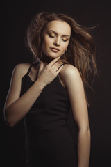 Naklejka premium Sensual brunette model with closed eyes and long lush hair