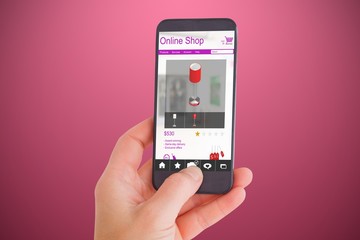 Composite image of female hand holding a smartphone