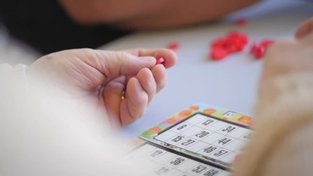 Old woman's hands playing bingo