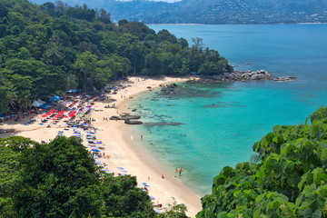 Fototapeta na wymiar Top view of the beach with people and azure sea