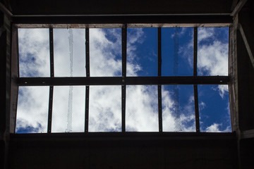 Clouds on the blue sky, through the lattice on the ceiling