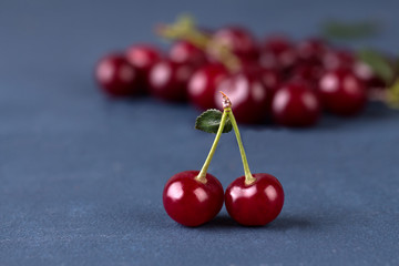 Cherries on grey stone background