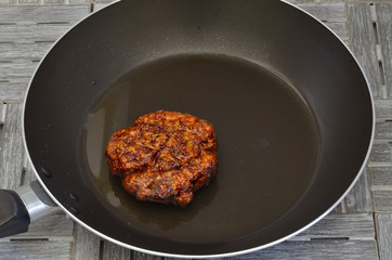 Meatball in a Frying pan / single meatball in a frying pan, close up, macro, full frame
 