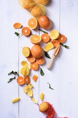 Fresh oranges, slices of orange fruits for making juice. Ripe citrus fruits with juice squeezer.
