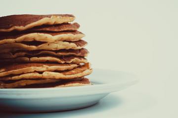 A stack of plain pancakes on a white plate background. isolated