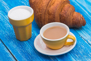 cup of coffee with croissant
