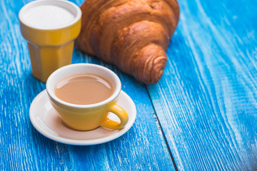 cup of coffee with croissant