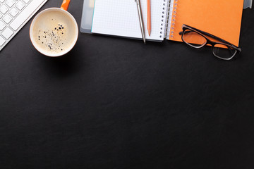 Office desk with coffee and supplies