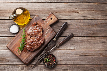 Grilled beef steak with spices on cutting board