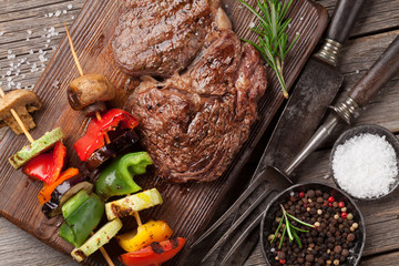 Beef steak and grilled vegetables on cutting board