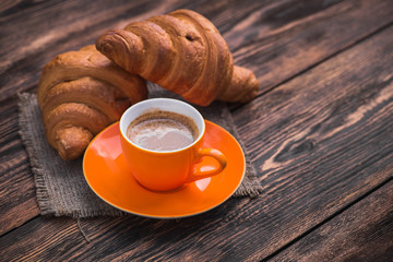 delicious coffee cup with croissant
