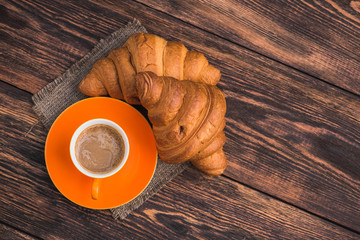 delicious coffee cup with croissant