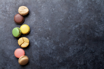 Obraz na płótnie Canvas Colorful macaroons on stone table. Sweet macarons