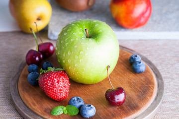 Fresh fruits on a wooden cutting board