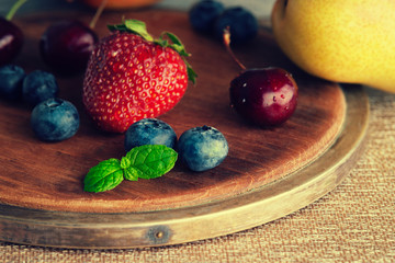 Fresh fruits on a wooden cutting board