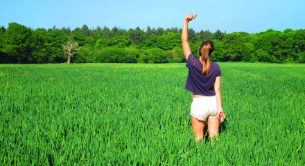 Young Caucasian White Woman in Barley Farm Field on a Sunny Blue Sky Day, England, UK