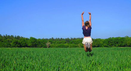 Young Caucasian White Woman in Barley Farm Field on a Sunny Blue Sky Day, England, UK