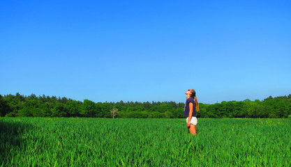 Young Caucasian White Woman in Barley Farm Field on a Sunny Blue Sky Day, England, UK