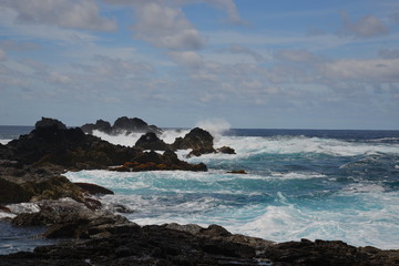 the village "mosteiros" on the island of azores with its black beaches, the breaking waves of the atlantic and the rock " ilh&eacute;us dos mosteiros;