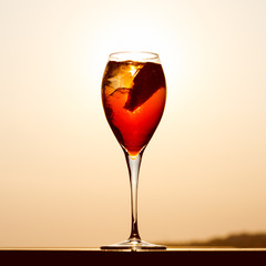 Aperol spritz at a wooden pier at sunset. Luxury resort vacation concept. Festive relax getaway background.