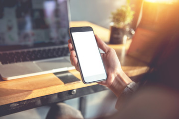 Close up of women's hands holding smart phone with blank copy space white screen for create content.