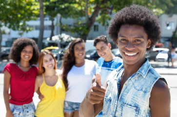 Fototapeta premium African american guy showing thumb with group multi ethnic people