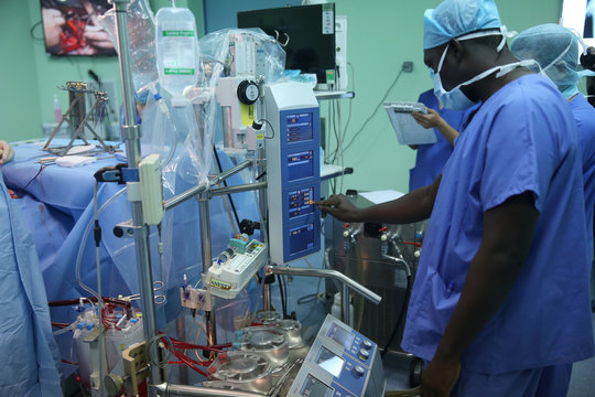 Doctor operating heart lung machine in the operating room