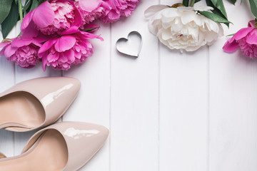 Beautiful peonies and beige woman shoe