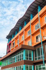 Orange and red buildings on blue sky background.