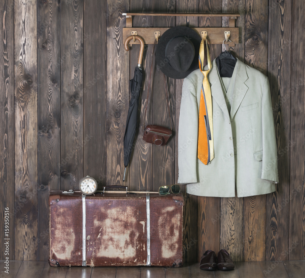 Wall mural Hanger with clothes, old suitcase,White suit