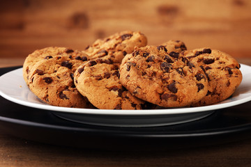 Chocolate cookies on wooden table. Chocolate chip cookies shot