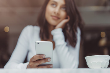 Beautiful woman using smartphone at coffee shop,