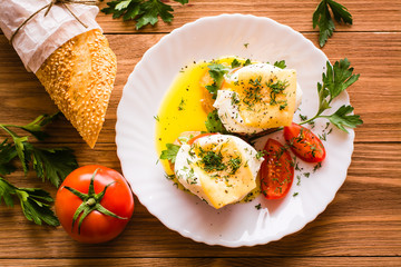 Sandwiches with poached egg, tomato, parsley and cheese. Top view