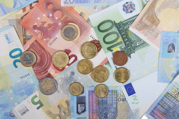 Euro bank notes with metal coins, bills background and texture