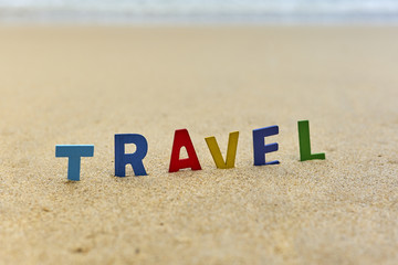 TRAVEL wood letters on the beach