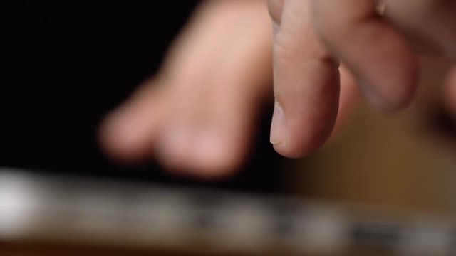 Woman writes on her computer, finger side
