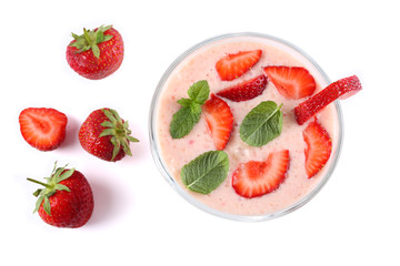 Healthy strawberry yogurt with mint leaves and fresh berries isolated on white background. Top view.