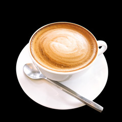 Hot coffee cappuccino cup with spiral milk foam isolated on black background, clipping path included.